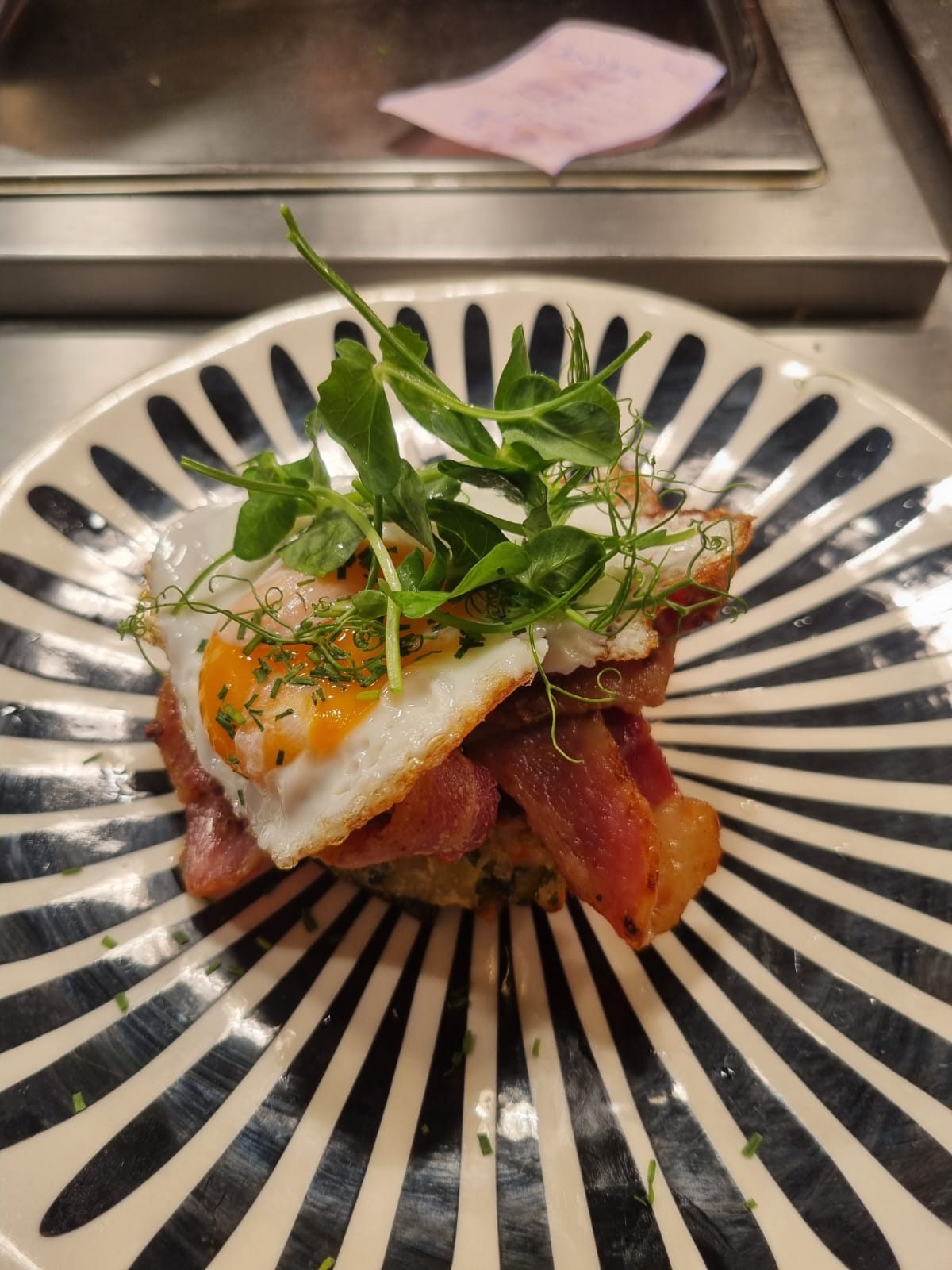 Bubble and squeak topped with bacon and fried egg