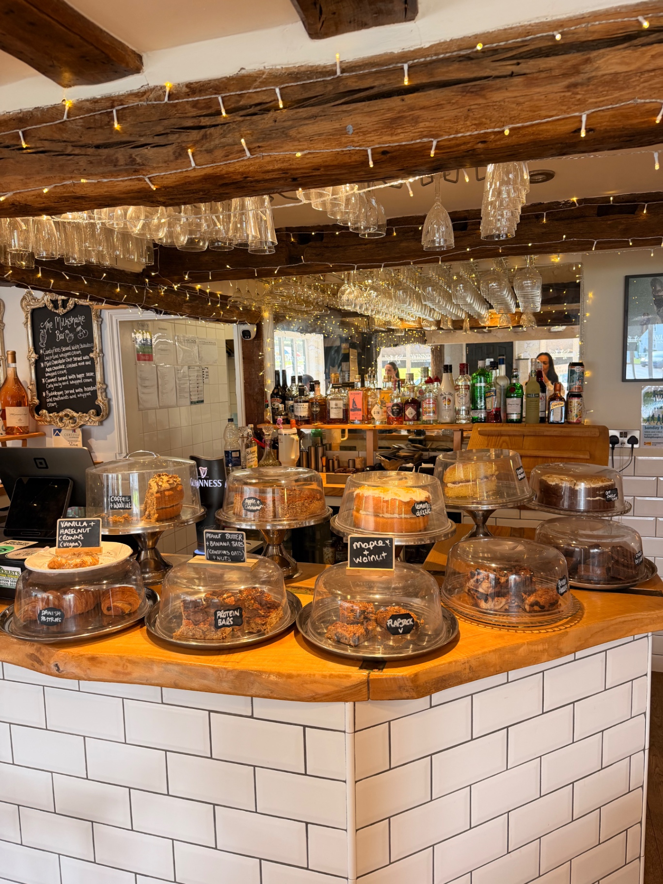 Cake counter inside Winners with hanging glassware and fairy lights